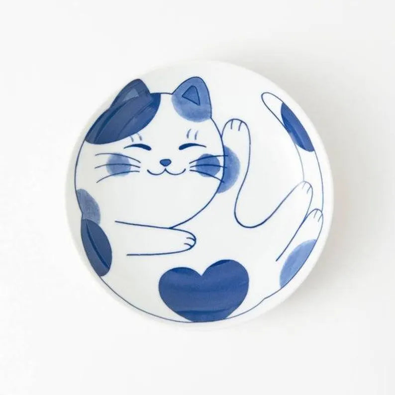 Ceramic plate with a blue and white cat design on a white background