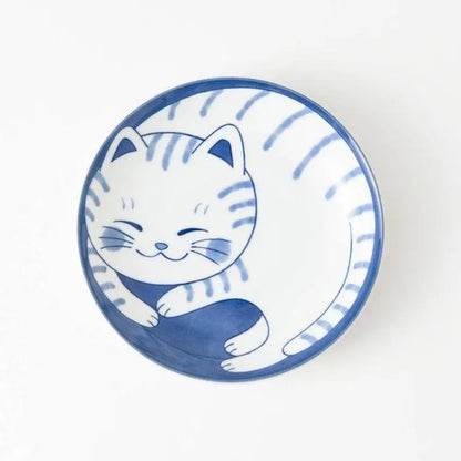 Ceramic bowl with a blue and white cat design on a white background